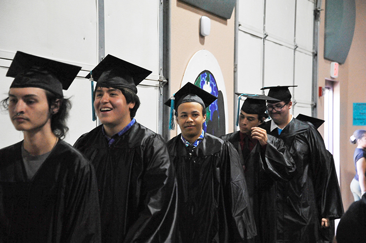 Graduates file into the auditorium