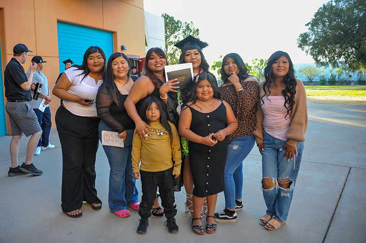 A graduate smiles with her family