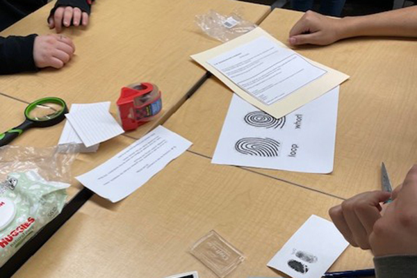 Students work on an escape room puzzle