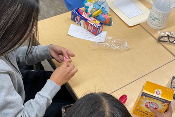 Students try to solve an escape room puzzle
