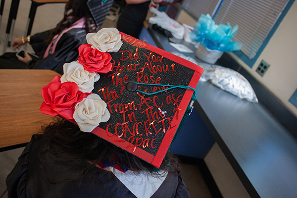 A girl shows off her decorated graduation cap